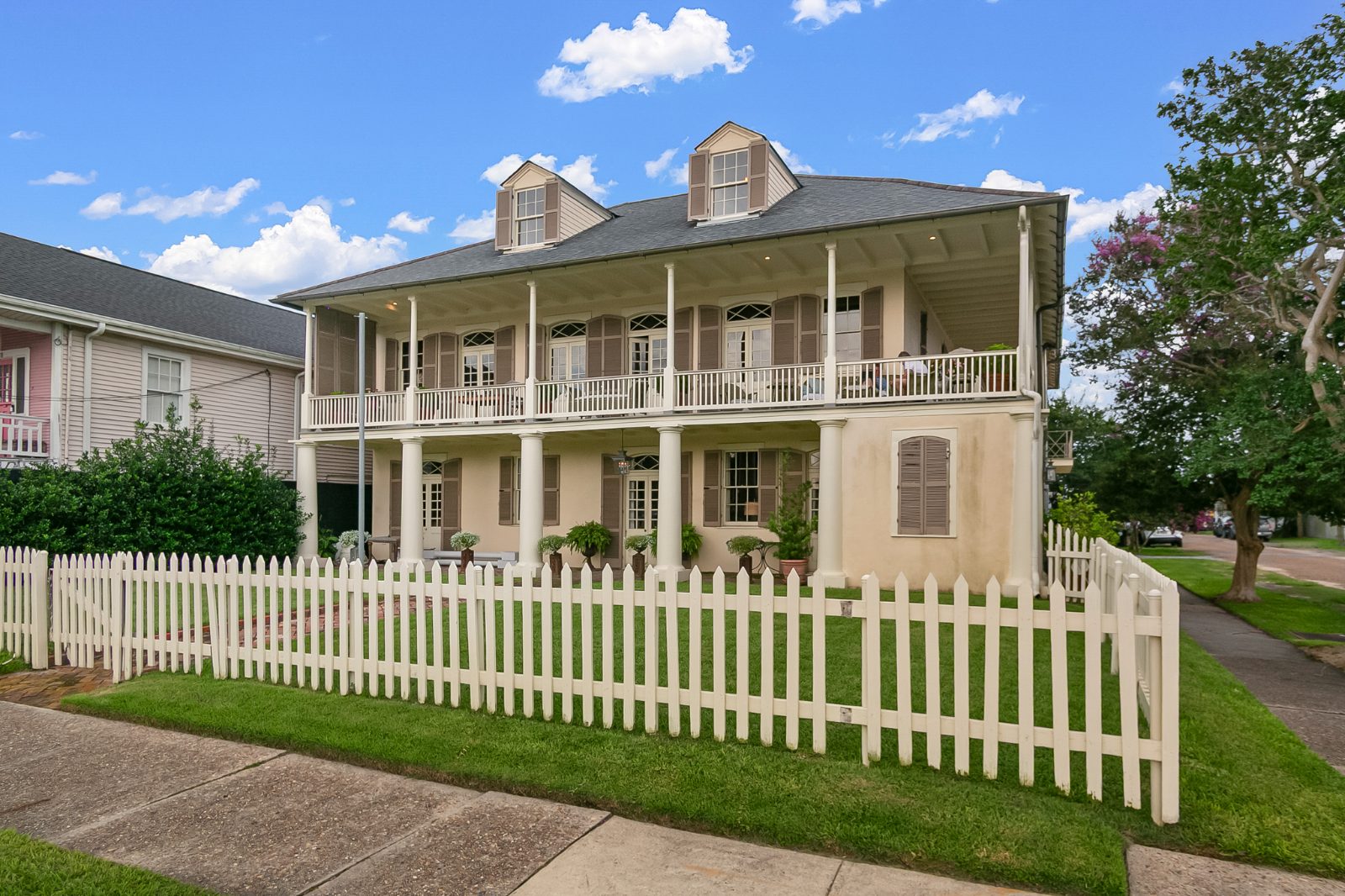 Two-story Louisiana home with double-gallery porches and a manicured yard