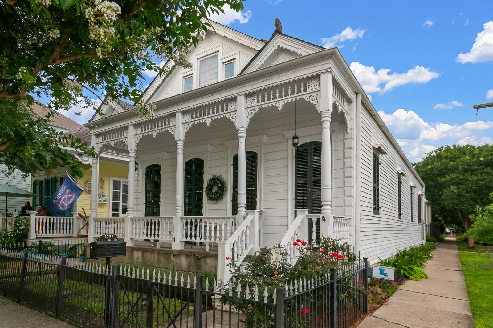Charming Louisiana cottage with ornate trim and a welcoming porch
